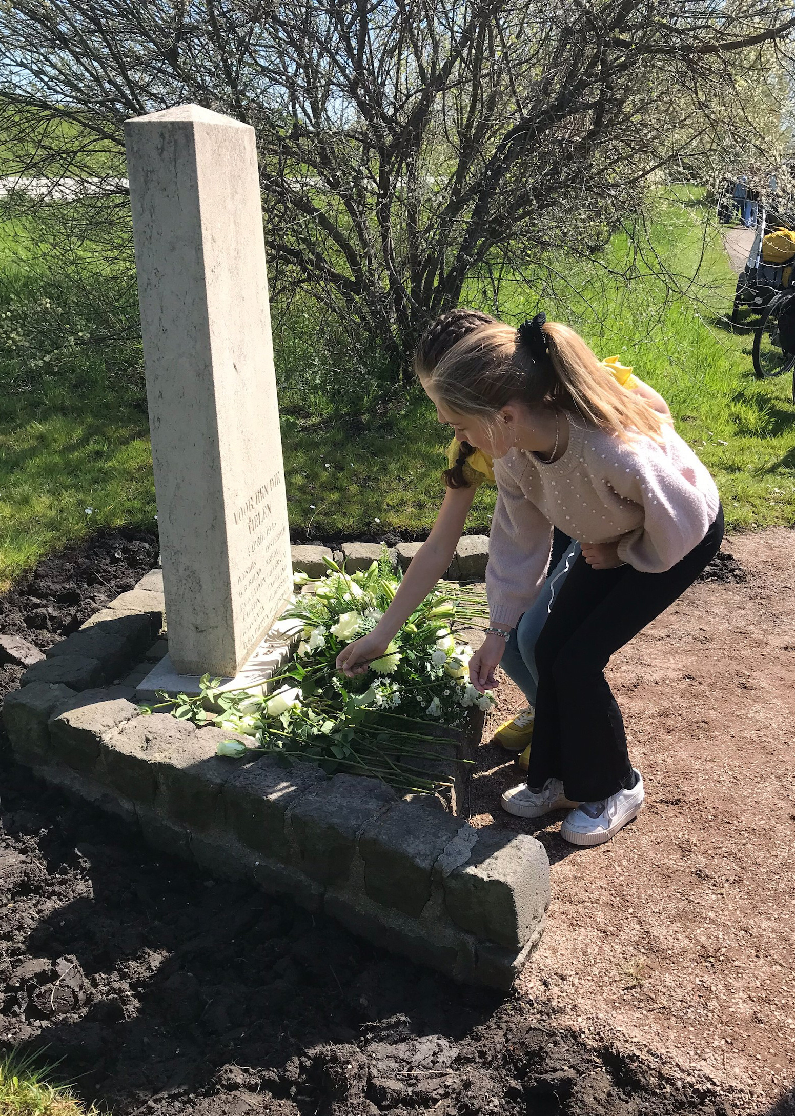 Monument Geldersedijk meisjes leggen bloemen